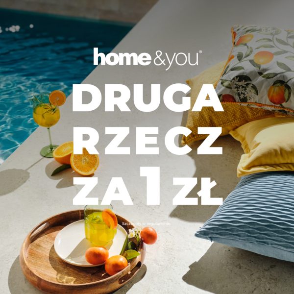 Letnia reklama marki home&you z poduszkami w żółtych i niebieskich odcieniach, owocami cytrusowymi oraz napojami ustawionymi przy basenie. Grafika informuje o ofercie, w której druga rzecz dostępna jest za 1 zł.