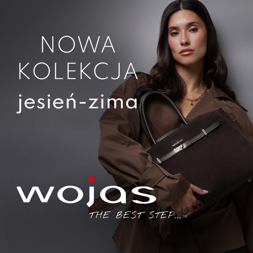 Kwadratowa fotografia reklamowa marki Wojas na szarym tle, przedstawiająca ciemnowłosą modelkę w brązowym płaszczu z paskiem, trzymającą dużą skórzaną torbę w odcieniu ciemnego brązu. Po lewej stronie umieszczono biały napis NOWA KOLEKCJA jesień-zima, a w dolnej części widnieje duże białe logo wojas z czerwoną kropką nad literą j oraz napisem THE BEST STEP....